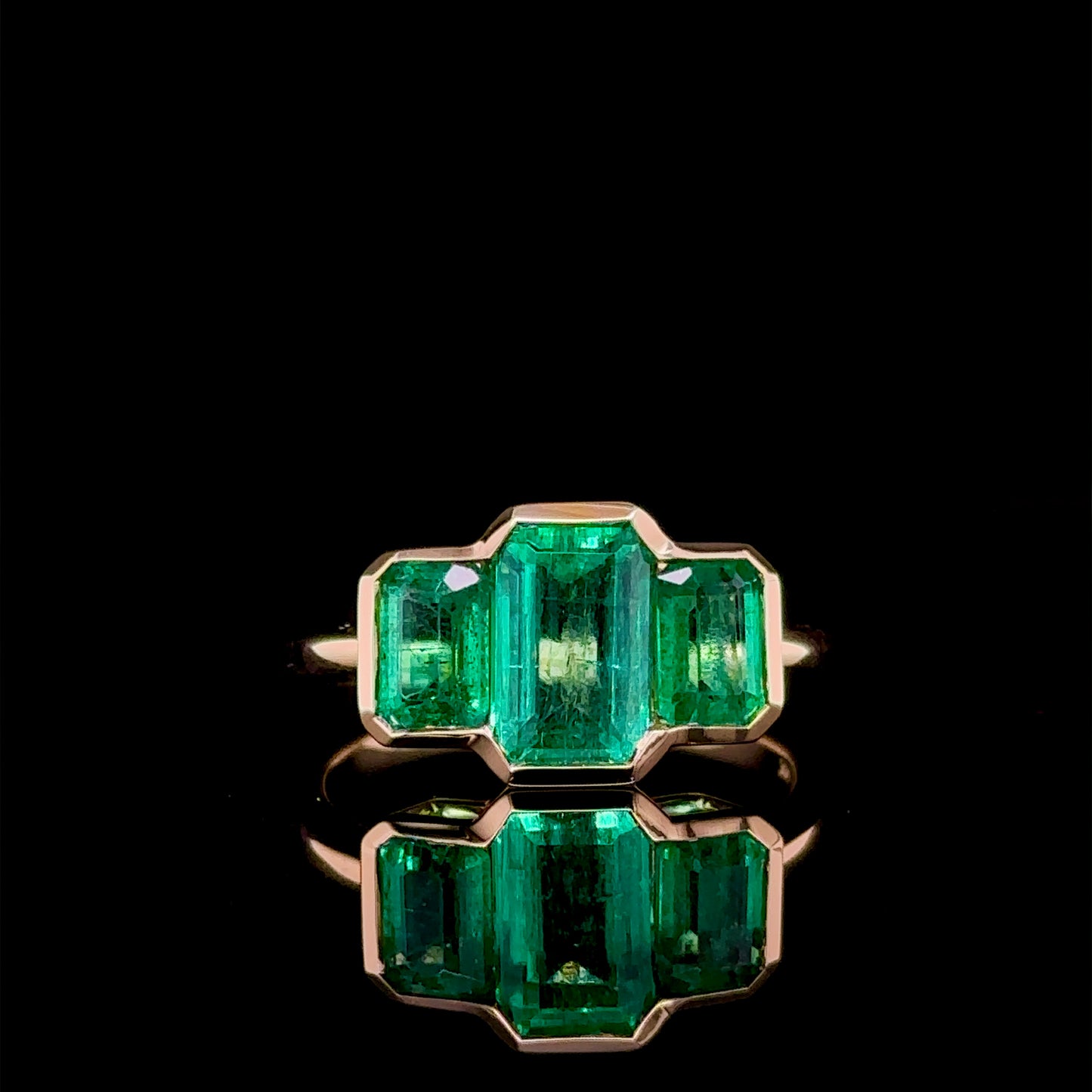 2.64 Carat Shared Bezel Three Stone Emerald Ring
