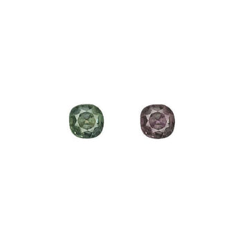 Round alexandrite gemstones, dark green and deep purple, side-by-side
