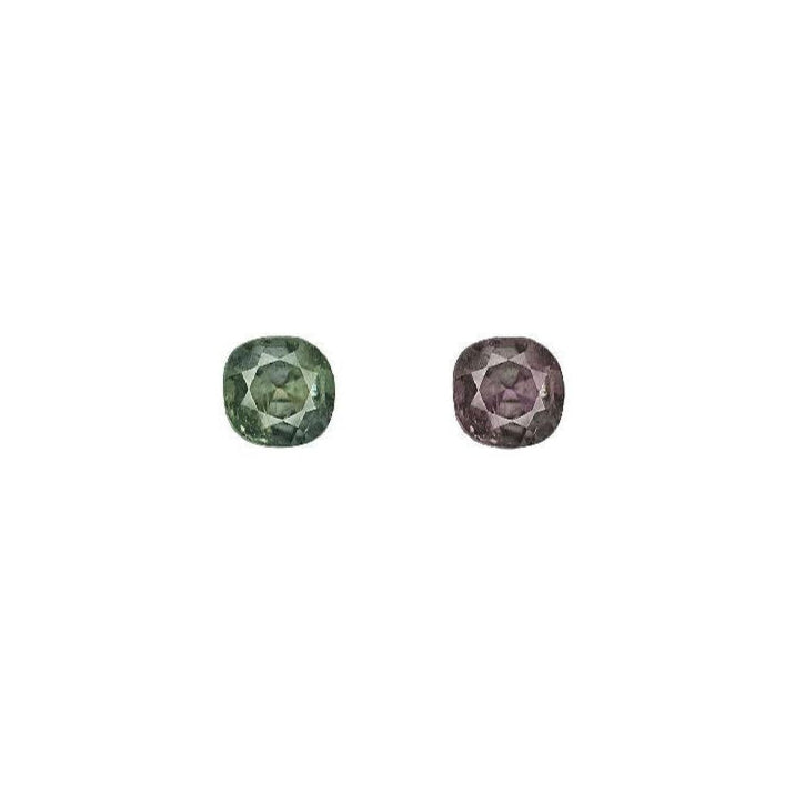 Round alexandrite gemstones, dark green and deep purple, side-by-side