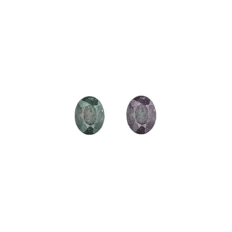 Oval alexandrite gemstones, one green and one purple, faceted for shine