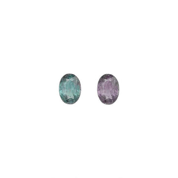 Pair of oval alexandrite gemstones: teal-green left, purple right