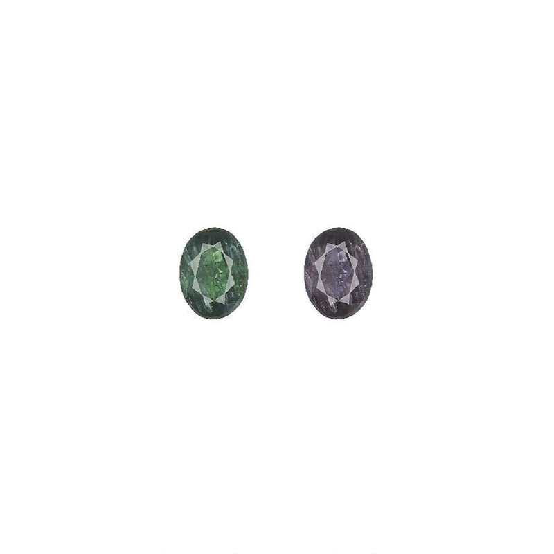 Oval alexandrite gemstone pair, one green and one purple