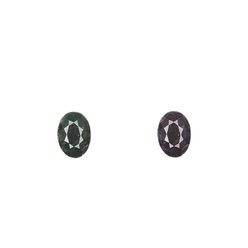 Oval alexandrite gemstones, dark green and dark purple in a pair