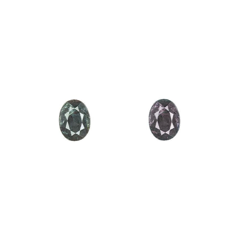 Faceted oval alexandrite gemstone, dark green changing to dark purple, loose stones
