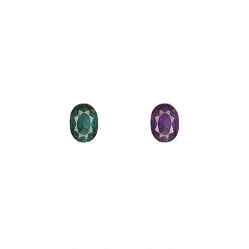 Oval alexandrite gemstones, one green-blue and one purple
