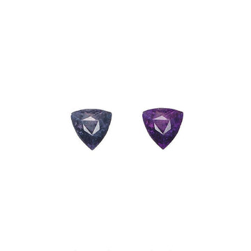 Pair of triangular alexandrite gemstones, blue-purple and vivid purple, faceted