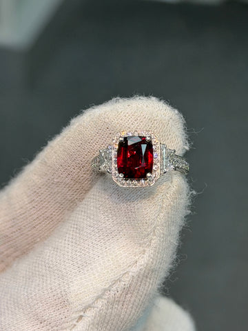 Platinum ring with square red ruby centerpiece and small diamond side accents