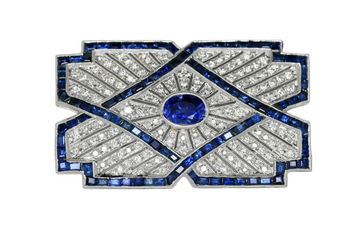 Geometric sapphire and diamond brooch with blue center stone and white gold frame