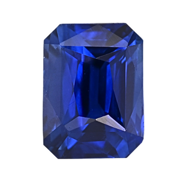 Blue sapphire gemstone close-up with step-cut facets, deep blue
