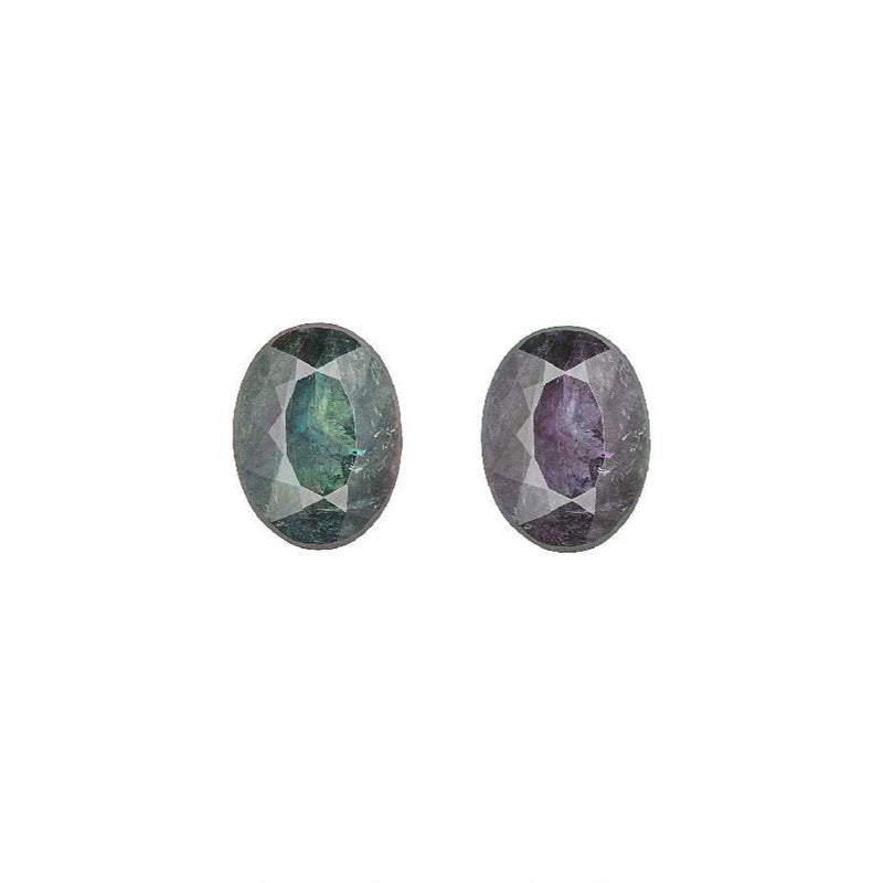 Pair of oval alexandrite gemstones, one blue-green and one purple, faceted