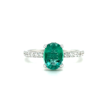 Gemstone ring with oval green emerald-cut center stone and diamond side accents