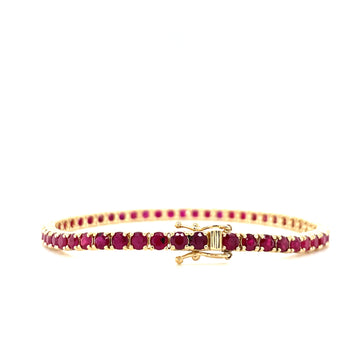 Ruby tennis bracelet with gold clasp and round deep red stones.