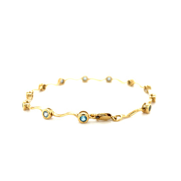14k yellow gold aquamarine bracelet with wave links and round blue stones