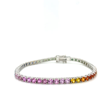 Rainbow ombre sapphire tennis bracelet with clasp at back, white background view.