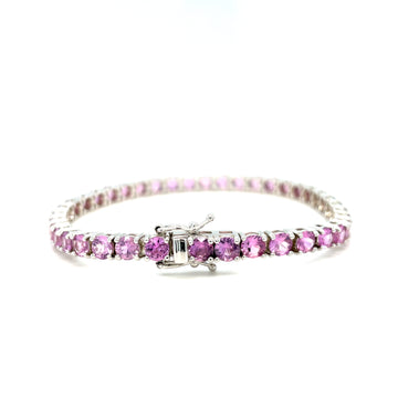 Pink sapphire tennis bracelet with oval pink stones and central bar setting