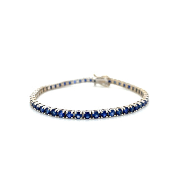 Blue sapphire tennis bracelet, round stones line across silver-toned band