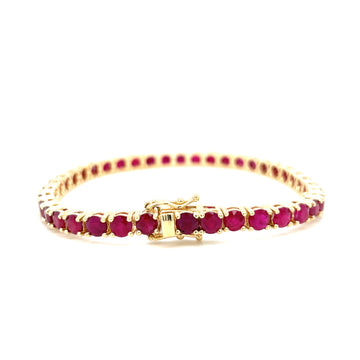 Gold tennis bracelet with oval red ruby stones and box clasp