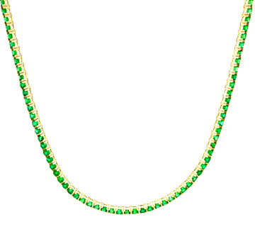 Emerald tennis necklace with green gemstones in yellow gold, curved close-up.