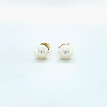 Round white pearl stud earrings with 14k yellow gold backings and posts