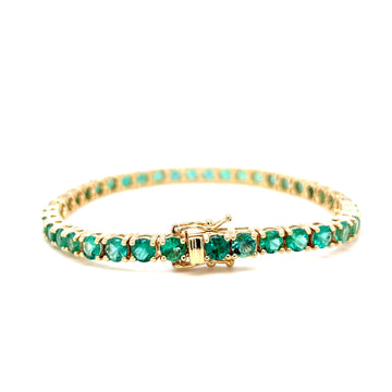 Emerald tennis bracelet with round green gemstones in gold-tone setting, flat view