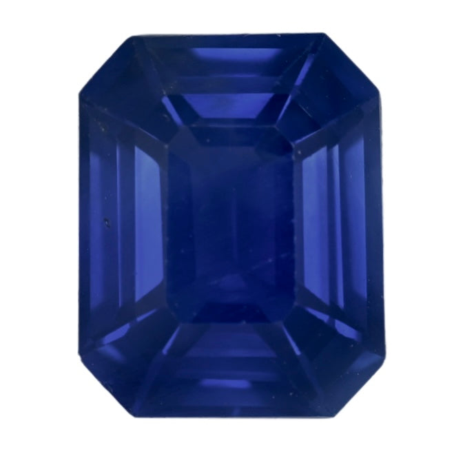 Close-up emerald-cut deep blue sapphire with step facets