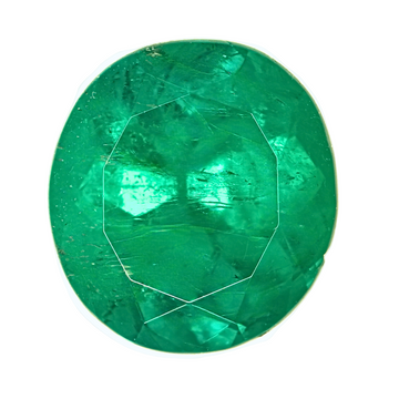 Round green emerald gemstone close-up showing faceted gem facets