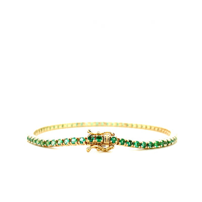 Emerald tennis bracelet with gold clasp, green gemstones in a continuous row