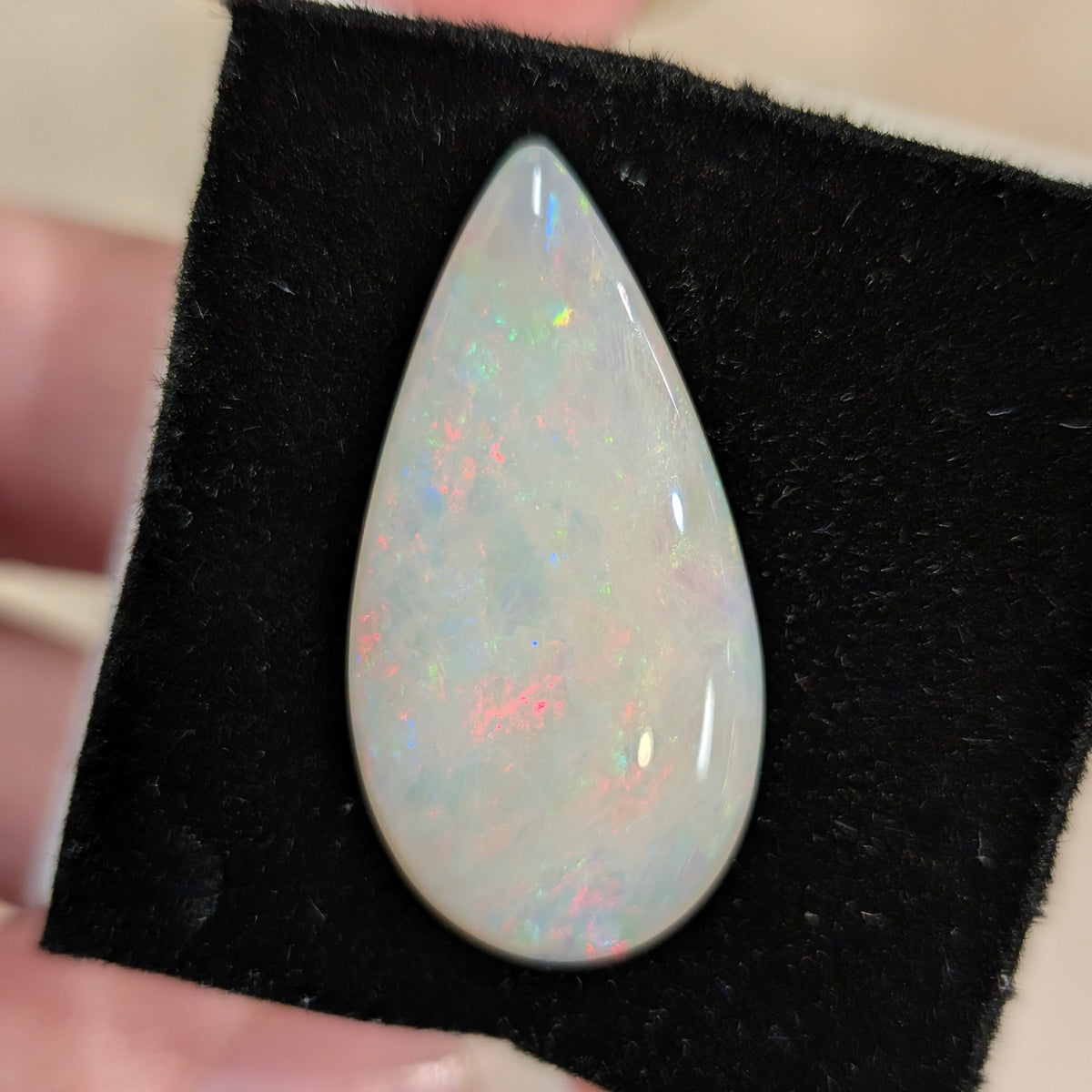White opal teardrop cabochon with colorful iridescent sparkle