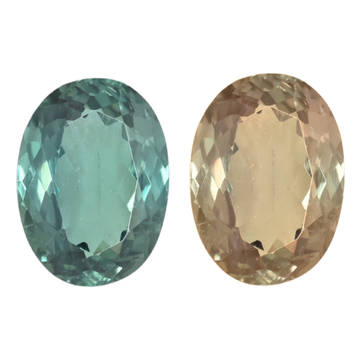 Two oval alexandrite gemstones: teal-green and light champagne faceted