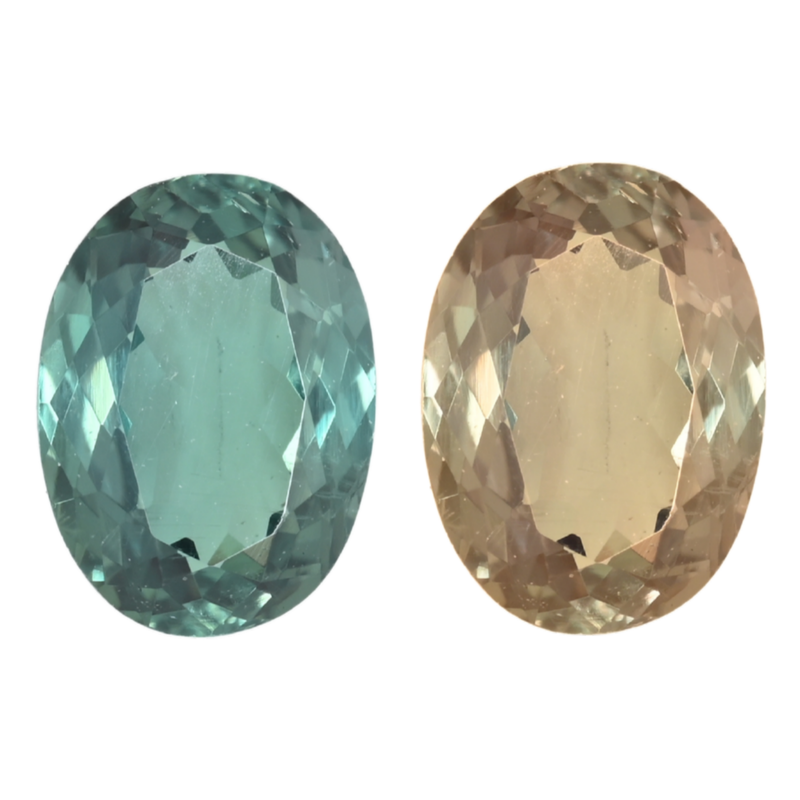 Two oval alexandrite gemstones: teal-green and light champagne faceted