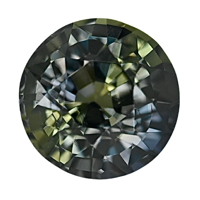 Round faceted green sapphire gemstone with dark smoky tones and bright light reflections