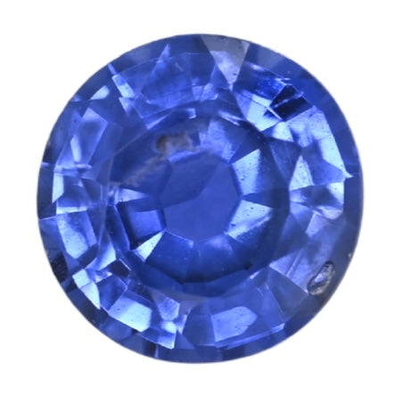 Round blue sapphire gemstone with faceted cut and reflective sparkle