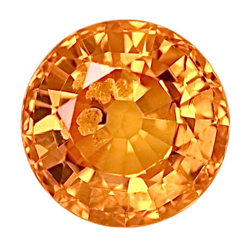 Round orange sapphire gemstone with faceted cut, polished finish