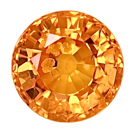 Round orange sapphire gemstone with faceted cut, polished finish
