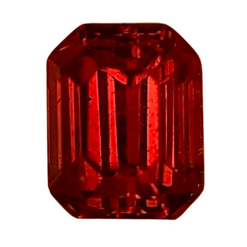 Close-up octagonal red ruby gemstone, high-contrast facets