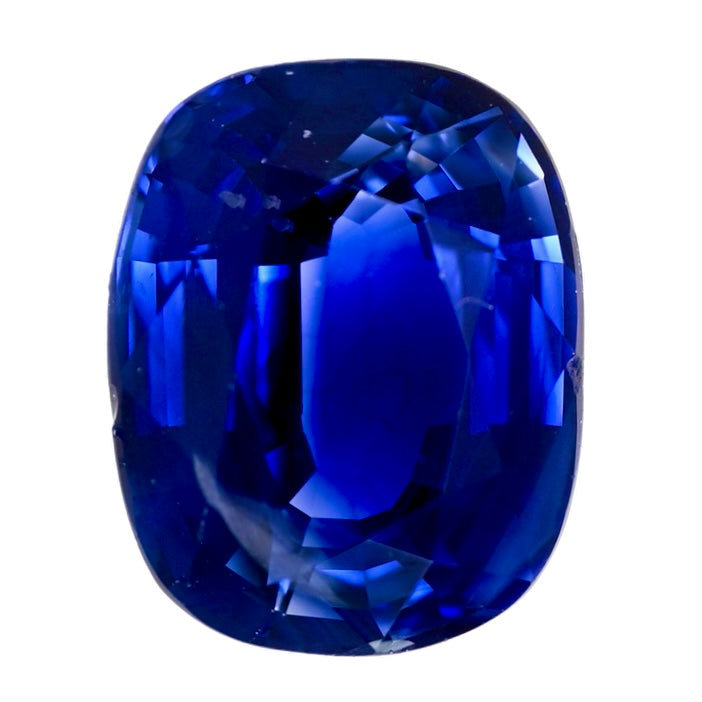 Oval-cut blue sapphire gemstone, deep royal blue with faceted sparkle.