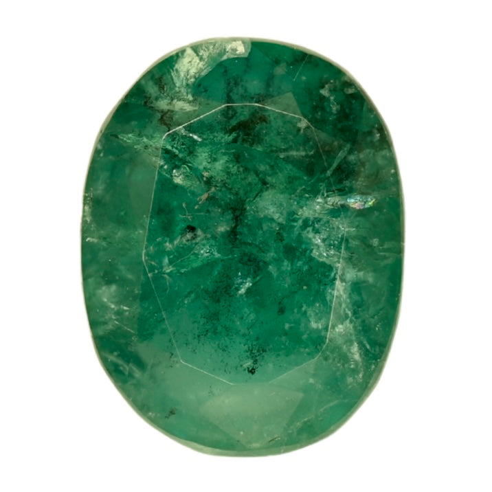 Green oval emerald gemstone, faceted with visible natural inclusions and facets