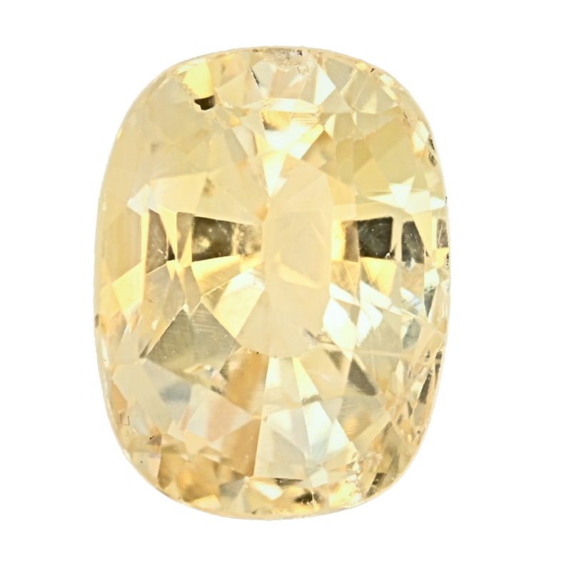 Faceted cushion-cut yellow sapphire gemstone close-up