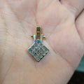 Two-tone gold square diamond pendant with clustered stones and thin border setting.