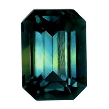 Emerald-cut bi-color sapphire, dark teal and green with facet sparkle