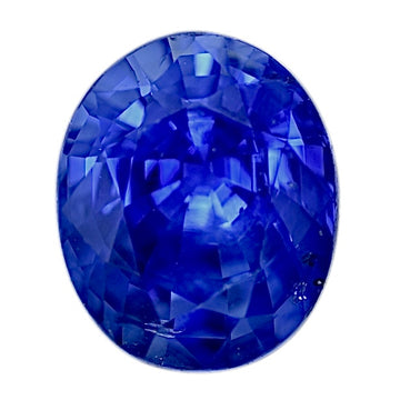 Round blue sapphire gemstone with faceted surface, close-up