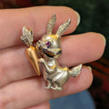 14k rabbit lapel pin, side view of gold-tone bunny with crystal ears and carrot
