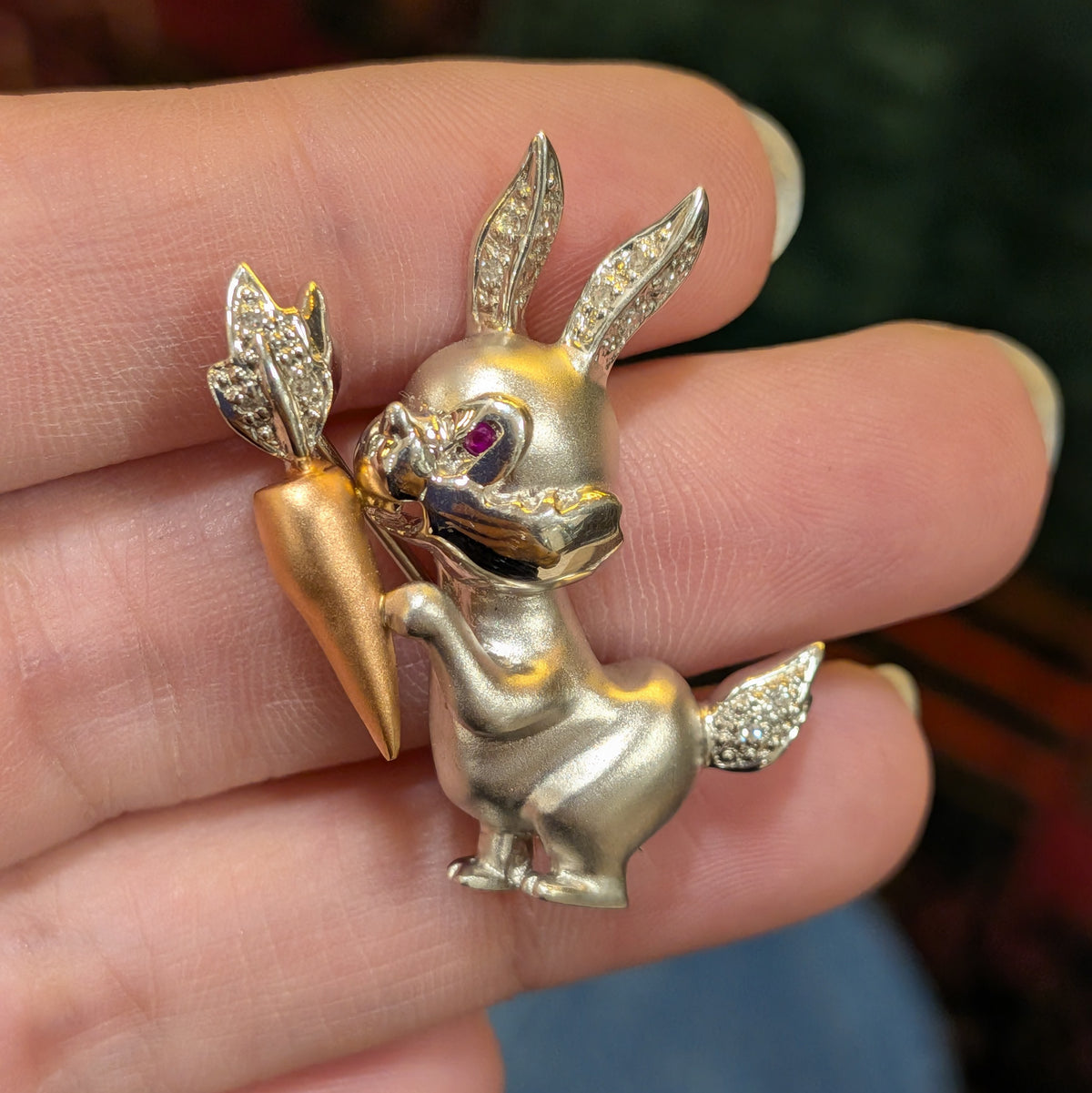 14k rabbit lapel pin, side view of gold-tone bunny with crystal ears and carrot