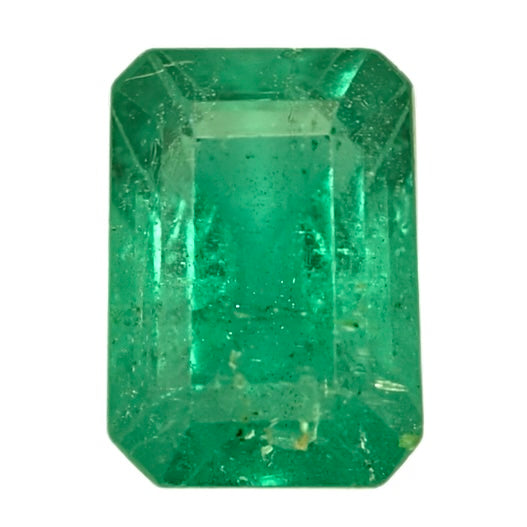 Emerald-cut green gemstone, bright emerald hue, faceted octagonal shape