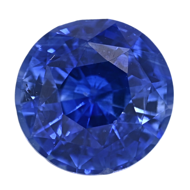 Close-up of faceted round blue sapphire gemstone, vivid deep blue luster