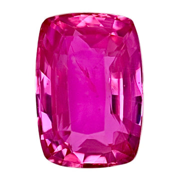 Pink cushion sapphire gemstone, faceted close-up