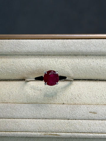 Ruby and black onyx ring with round pink center stone and slim metal band