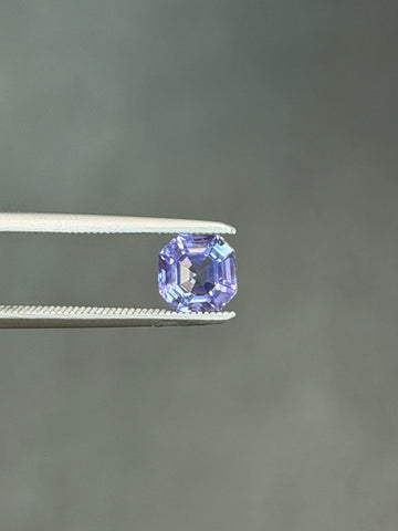 Lavender step-cut sapphire in a metal prong setting