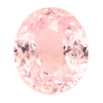 Close-up oval peach sapphire with faceted gemstone surface