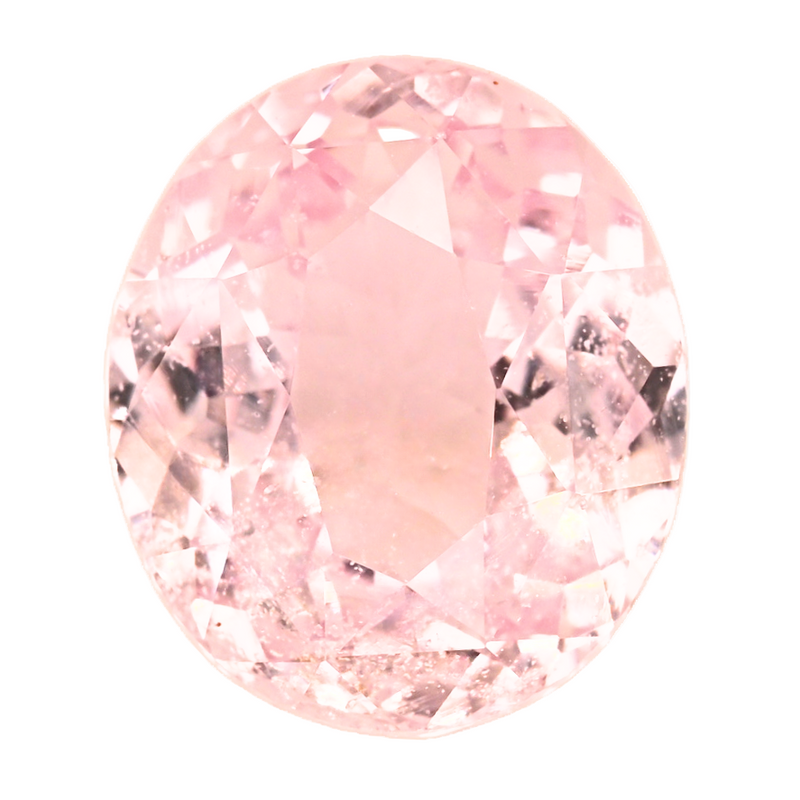 Close-up oval peach sapphire with faceted gemstone surface